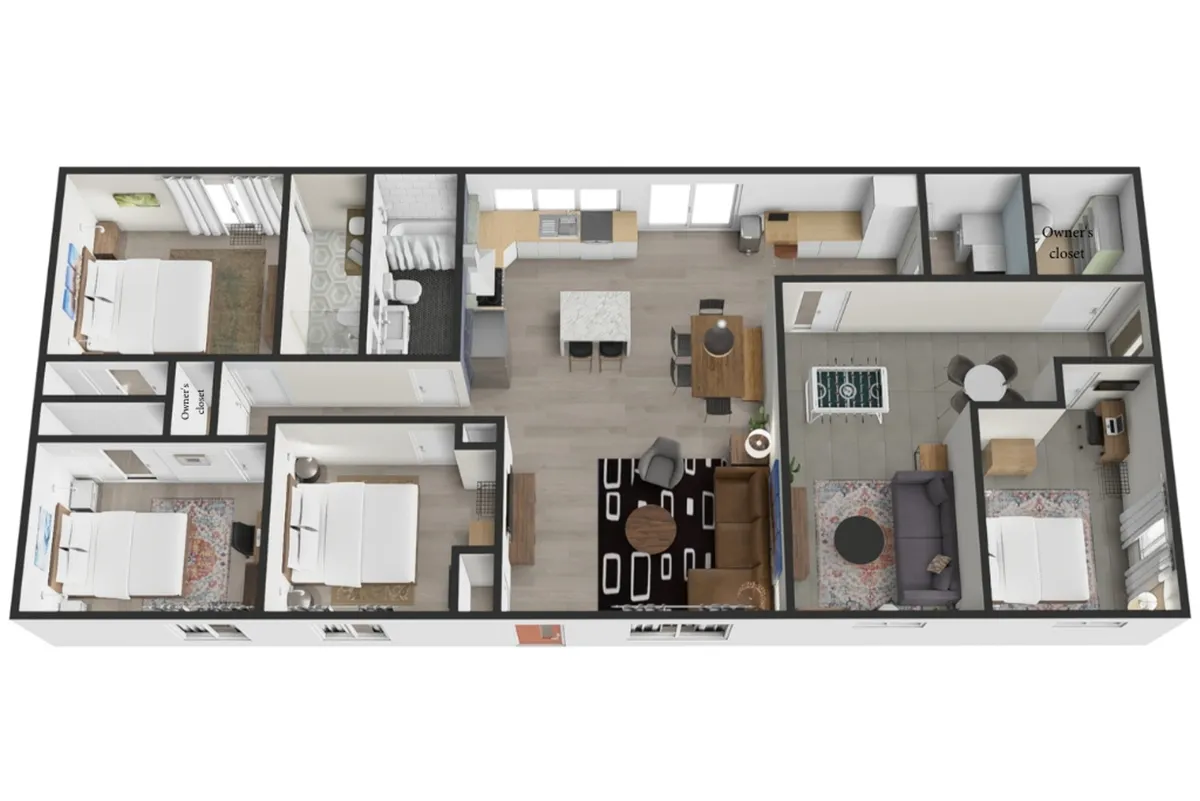 An open-plan interior shot that includes the living room seating area, dining table, kitchen island, and glimpses of bedroom setups. The scene conveys warmth and togetherness, with a focus on communal spaces designed for gatherings.